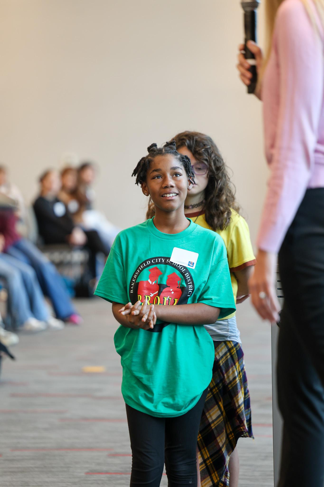 Student getting ready to ask keynote speaker questions