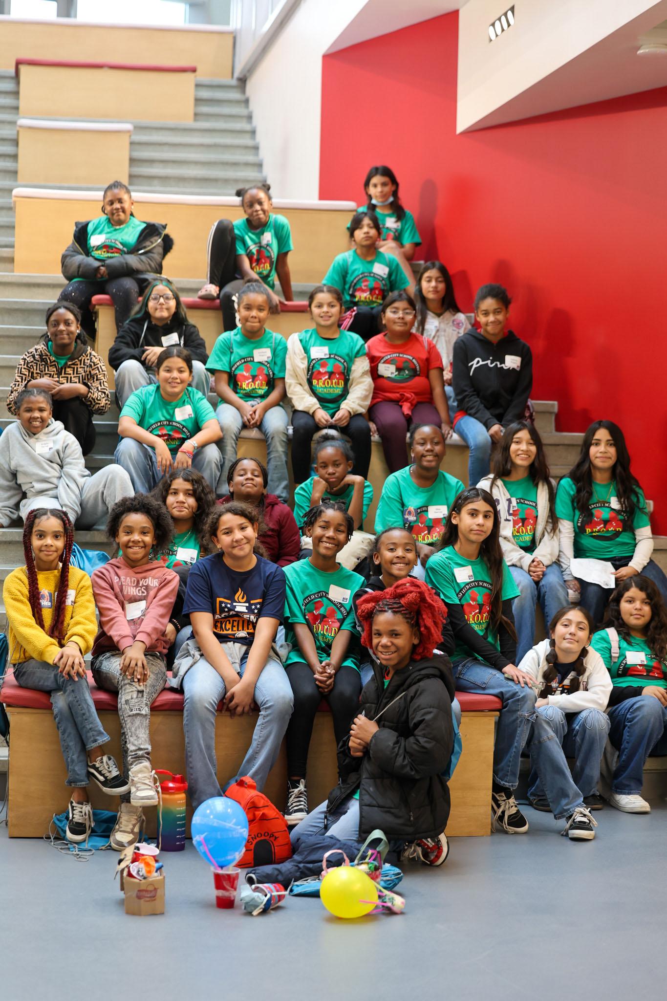 Students from PROUD Academy smiling for a group photo at the event